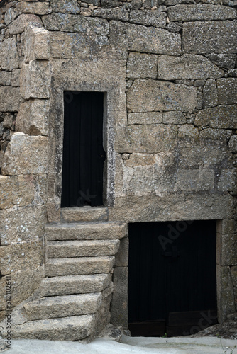 Fototapeta Naklejka Na Ścianę i Meble -  Old stone wall with dark wooden gate and door