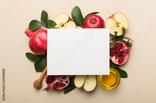 Fototapeta Naklejka Na Ścianę i Meble -  Flat lay composition with Blank flyer poster and symbols jewish Rosh Hashanah holiday attributes on colored background, New Year holiday Traditional. Top view with copy space mock up