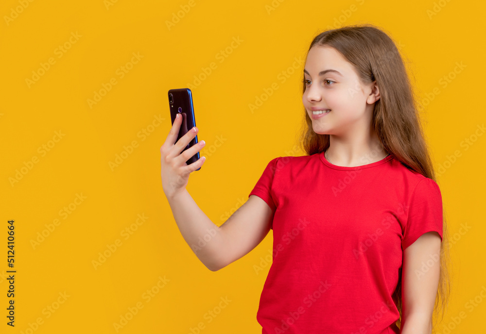 cheerful child with smartphone on yellow background cheerful child with smartphone on yellow background