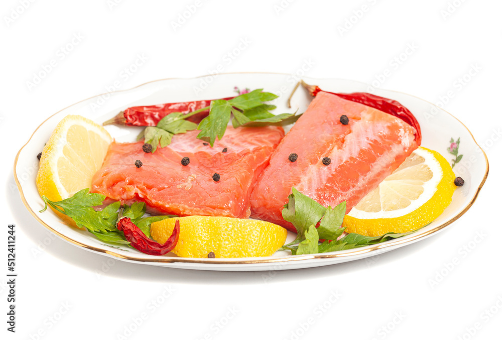 Pieces of lightly salted trout with spices and lemon isolated on white background Pieces of lightly salted trout with spices and lemon isolated on white background