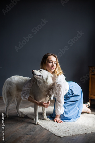 A young elegant tender woman loves her pet dog white albino husky breed girl hugs her fluffy dog