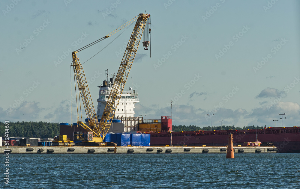 Huge industrial harbor cargo crane to load ships with containers and goods