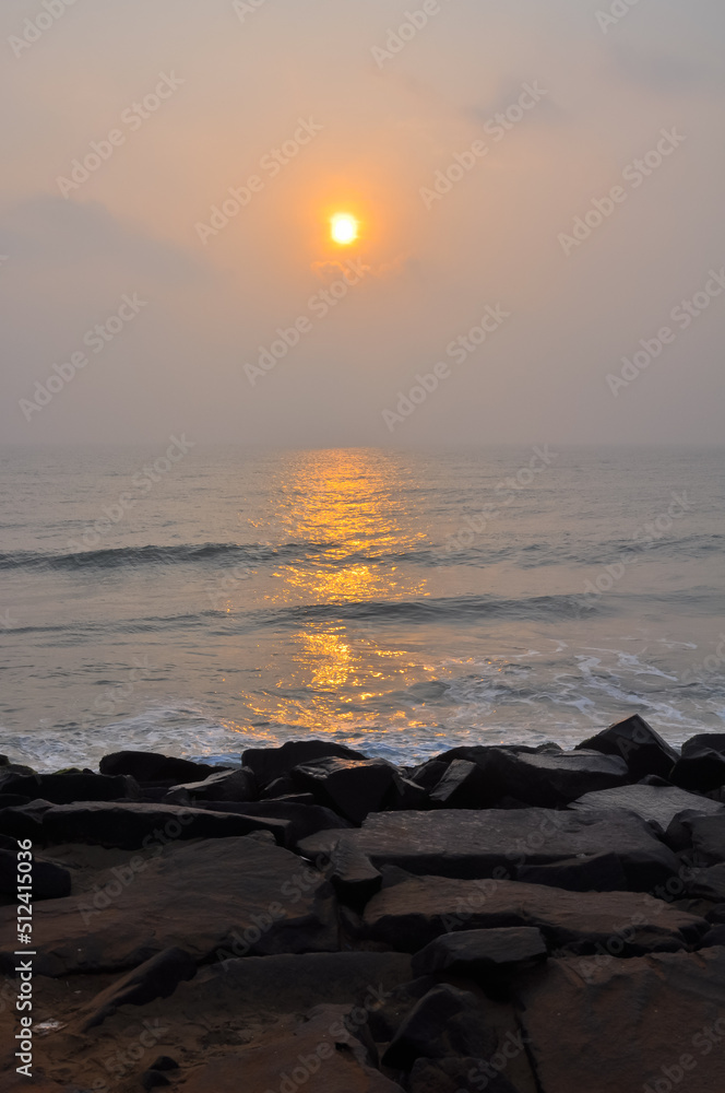 Huge stones on the ocean during a beautiful sunrise, Pondicherry, Tamil Nadu, India	