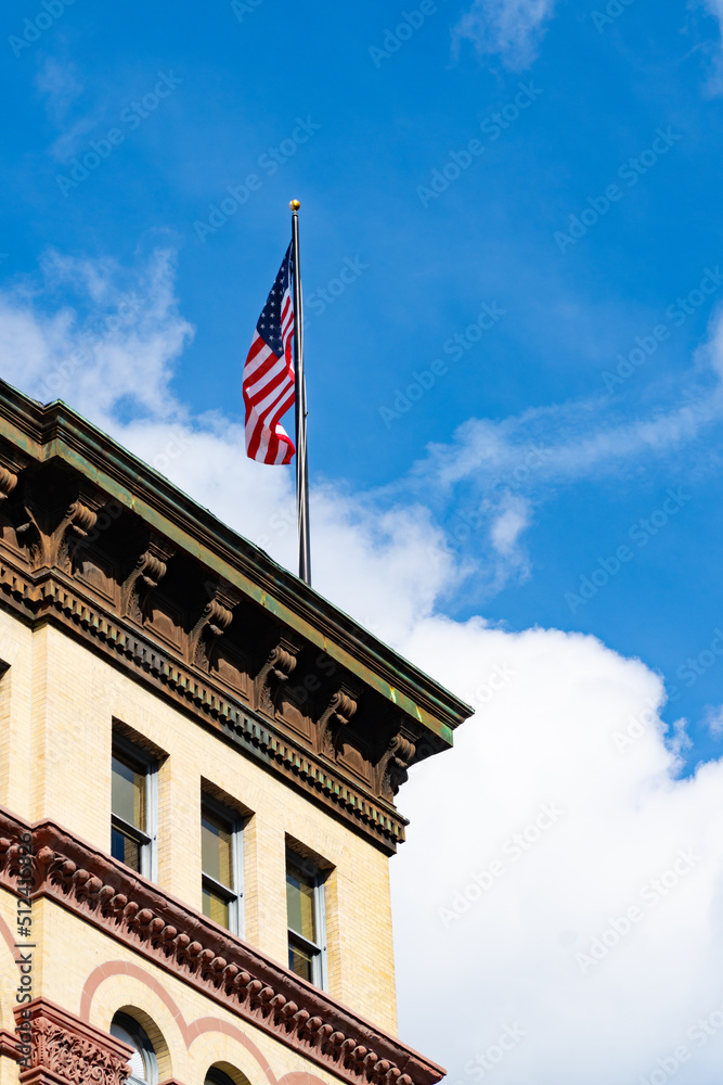 building and american flag with blue sky