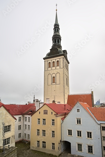 ell tower of Saint Nicholas church above the orange rooftops of Tallinn, Estonia 