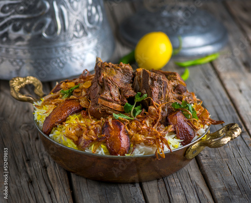 Spicy mutton biryani served in dish side view on wooden table background