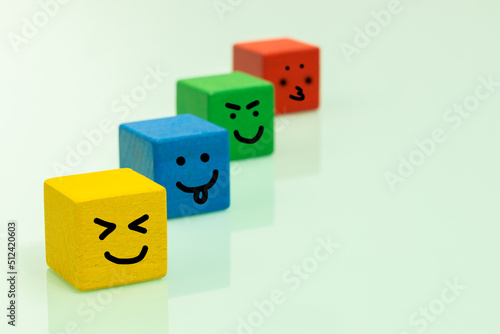 Colorful wooden blocks with emoticons Positive emotions, smiles, facial expressions, Concept of positive thinking and expressing feelings