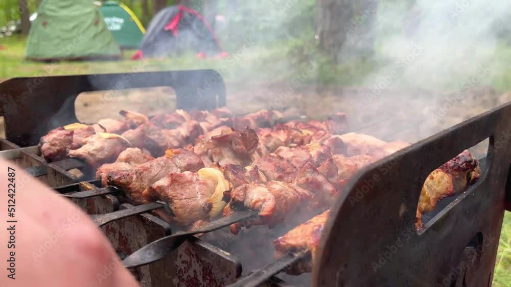 Grilling tasty dish on barbecue. Process of cooking yummy shashlik in nature Grilling tasty dish on barbecue. Process of cooking yummy shashlik in nature
