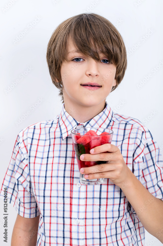 Teenage boy holding watermelon smoothie and smiling Teenage boy holding watermelon smoothie and smiling