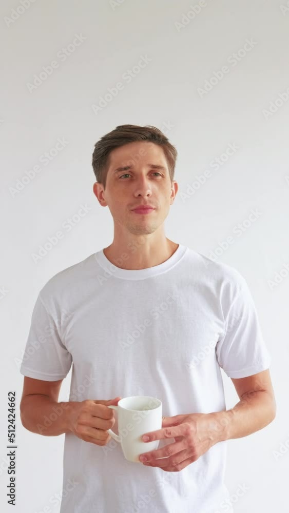 Lazy morning. New day. Enjoying coffee. Masculine charm. Confident handsome man with cup of beverage looking at camera isolated on white vertical. Lazy morning. New day. Enjoying coffee. Masculine charm. Confident handsome man with cup of beverage looking at camera isolated on white vertical.