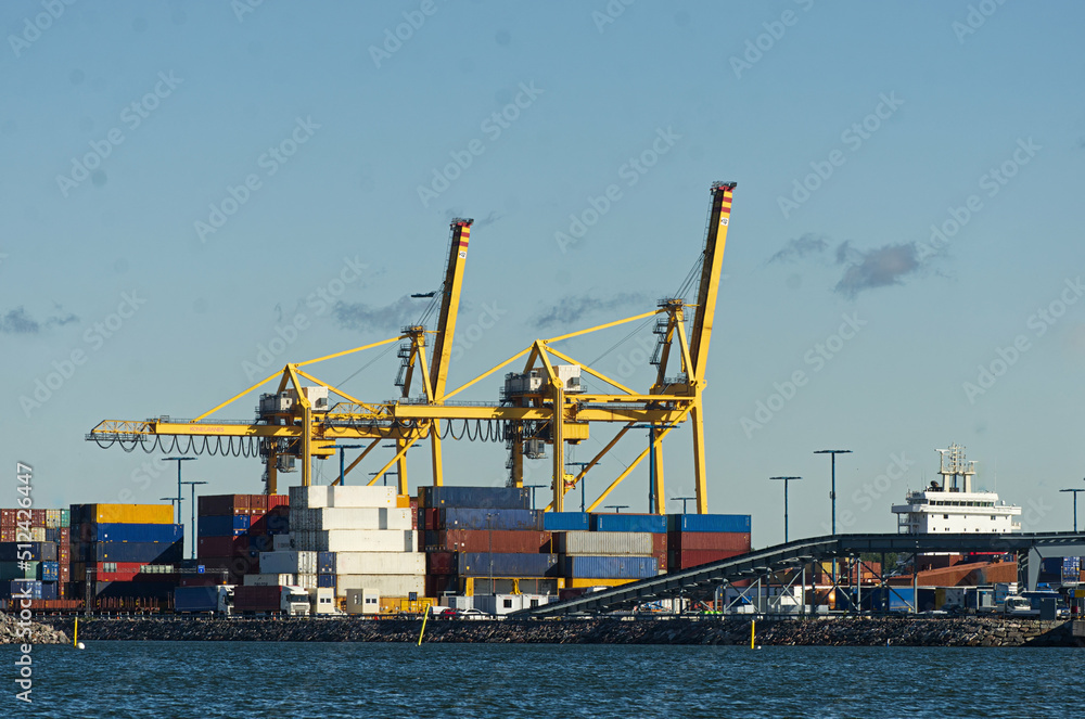 Cranes, ships and containers in a harbor port. 