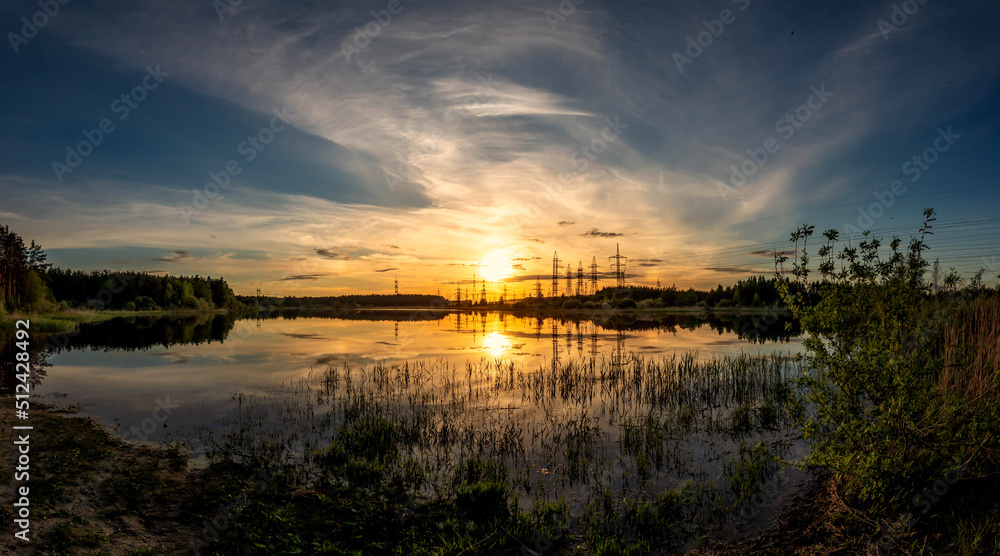 Panorama of a summer lake in the meadows. Summer sunset.