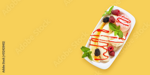 Summer fruit berry breakfast. Healthy banana split breakfast with white and pink ice cream , raspberries, blackberries, mint. On white plate. Top view, copy space