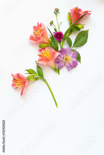 Delicate floral mockup on a white background isolated. Pink alstroemerias, lilac rose. Festive summer background and copy space.