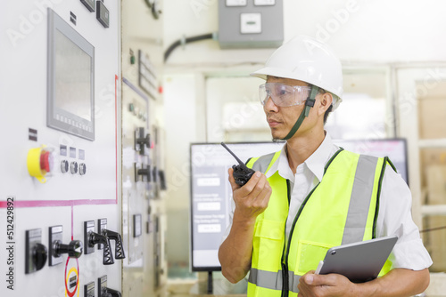 Electrical engineer holding tablet to inspecting the electrical system in a factory, energy concept.