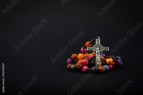 Obraz na plátně Traditional christian holy religious wooden rosary isolated on black background