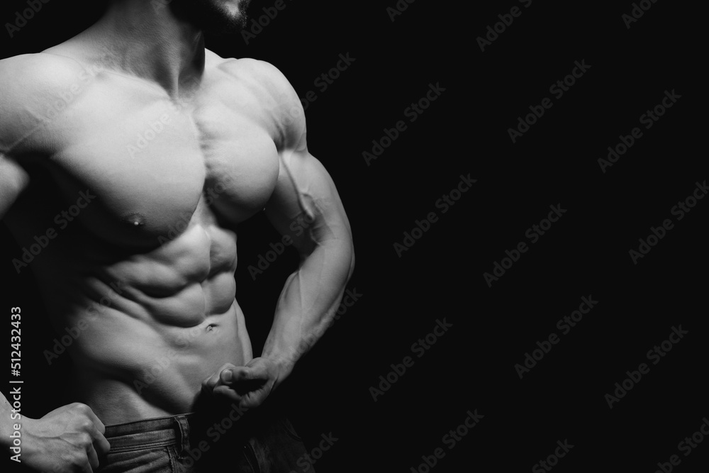 Fitness concept. Muscular and fit torso of young man having perfect abs, bicep and chest. Male hunk with athletic body on black background. Copypaste space. Fitness concept. Muscular and fit torso of young man having perfect abs, bicep and chest. Male hunk with athletic body on black background. Copypaste space.