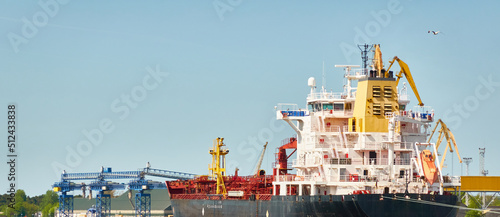 Vászonkép Large tanker ship loading in cargo port terminal