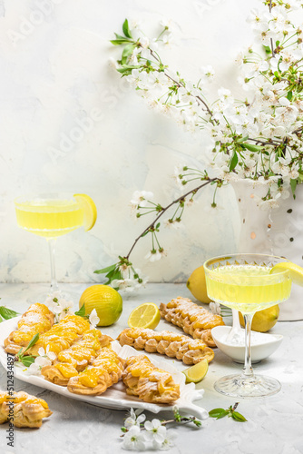 Limoncello. Traditional italian homemade alcoholic drink in glass with pieces of lemon, sweet Italian lemon liqueur. vertical image. top view. place for text