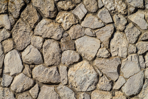 Texture of a stone wall. Old castle stone wall texture background. Stone wall as a background or texture. Rock , pattern, uneven cracked real stone, Gray