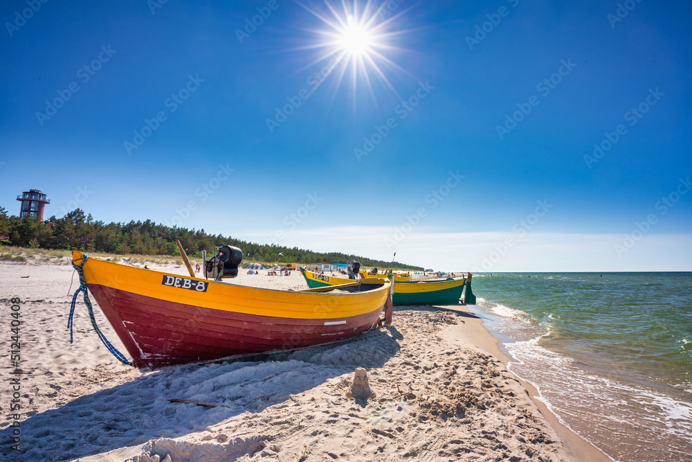 Fishing boat on the sunny Baltic Sea beach in Debki. Poland Fishing boat on the sunny Baltic Sea beach in Debki. Poland