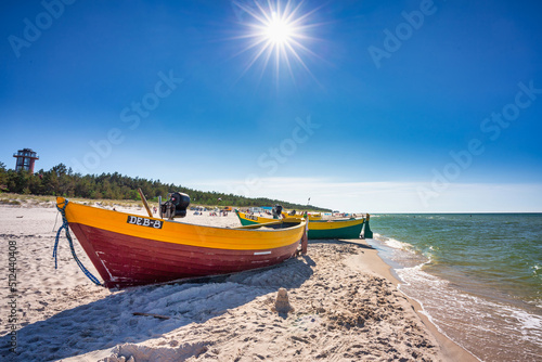 Fototapeta Naklejka Na Ścianę i Meble -  Fishing boat on the sunny Baltic Sea beach in Debki. Poland