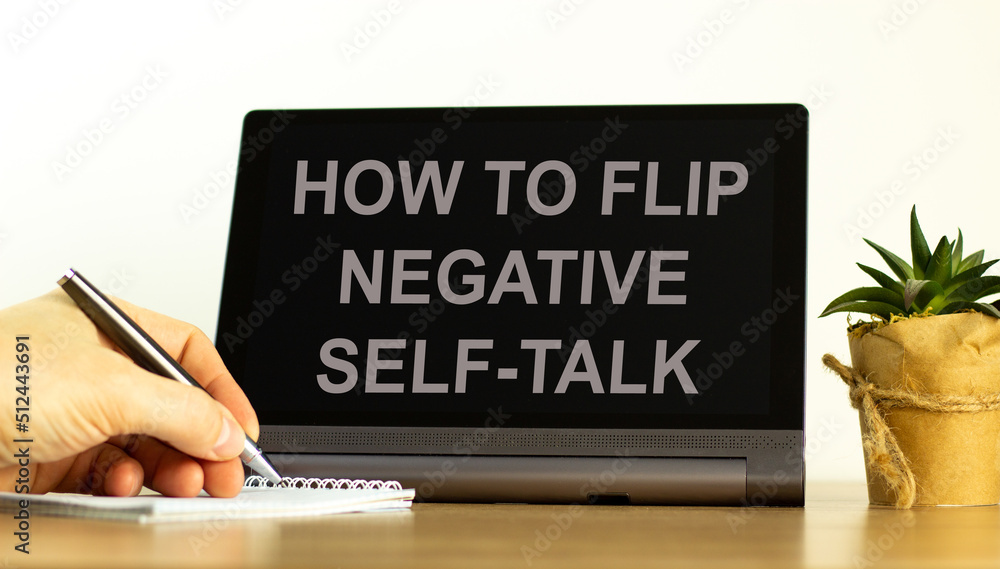 Flip negative self-talk symbol. Concept words How to flip negative self-talk on the black tablet. Businessman hand with pen. Psychological and flip negative self-talk concept. Copy space. Flip negative self-talk symbol. Concept words How to flip negative self-talk on the black tablet. Businessman hand with pen. Psychological and flip negative self-talk concept. Copy space.
