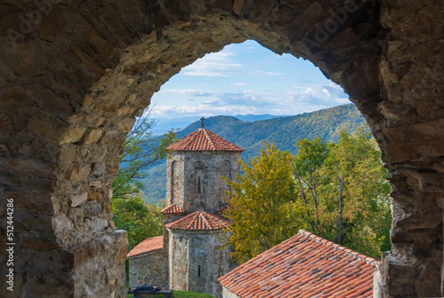 Old monastery complex located in scenic highlands on sunny day in Kakheti photo