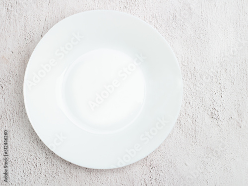 white shallow dish seen from above on rustic background