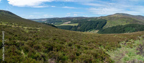 Panoramic view. Looking down a valley towards a town in Wicklow National Park in wicklow. Staturated colors.. Ideal day for hiking. © Marcin