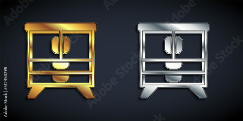 Gold and silver Chest of drawers icon isolated on black background. Long shadow style. Vector