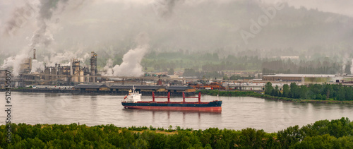 Columbia River at Longview, Washington. Large ship anchored in the Columbia River on a highly industrialized section near the Lewis and Clark Bridge.  photo