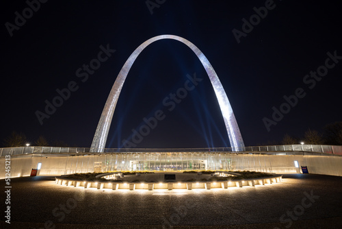 Glowing Gateway Arch National Park of St. Louis with spot lights at night time 