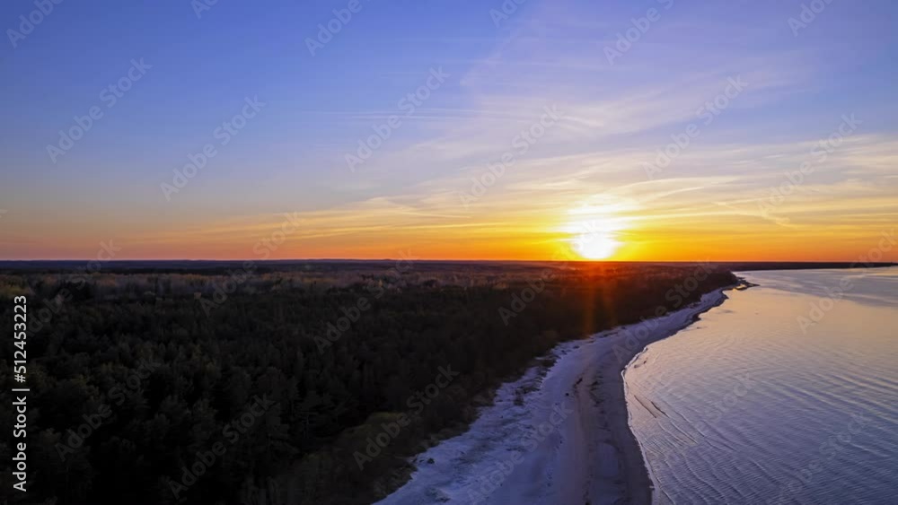 Evening beautiful sunset of the Jurmala sun that sets behind the Jurmala spruce forest, thaislaps in 4k Evening beautiful sunset of the Jurmala sun that sets behind the Jurmala spruce forest, thaislaps in 4k