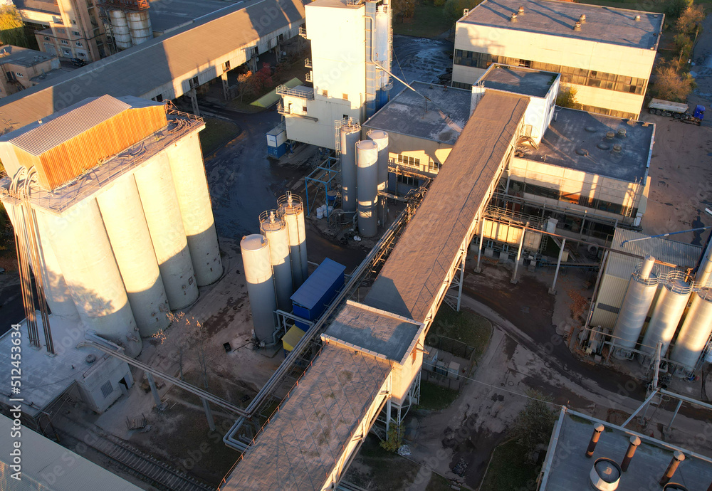 Industrial plant, top view. Cement plant for cement production. Cement Factory in city. Ecology concept and poor environment. Industrial plant, top view. Cement plant for cement production. Cement Factory in city. Ecology concept and poor environment.