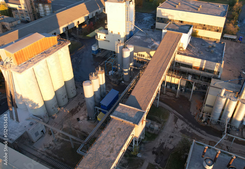 Industrial plant, top view. Cement plant for cement production. Cement Factory in city. Ecology concept and poor environment.