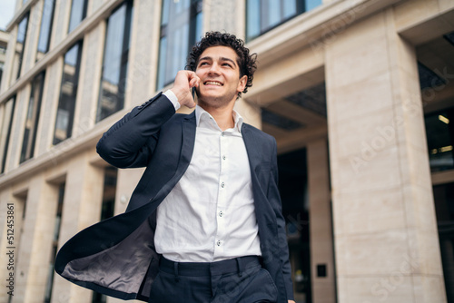 Wallpaper Mural The male manager uses the phone, answers the client Torontodigital.ca