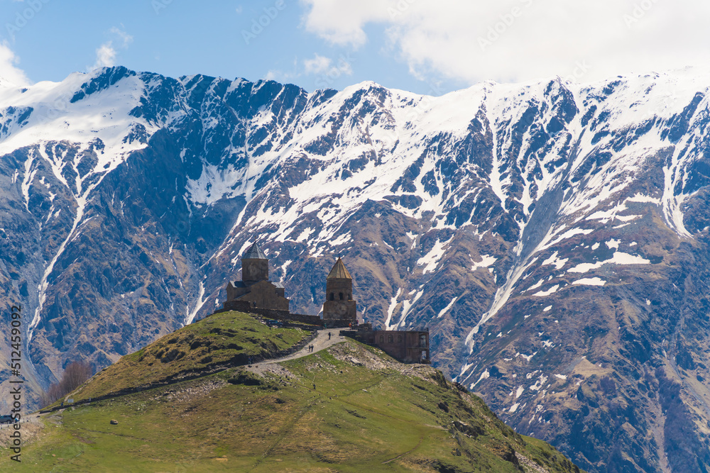 beautiful view of ancient Gergeti Trinity Church in Kazbegi, Georgia. snow-capped Caucasus mountains in the background. High quality photo beautiful view of ancient Gergeti Trinity Church in Kazbegi, Georgia. snow-capped Caucasus mountains in the background. High quality photo