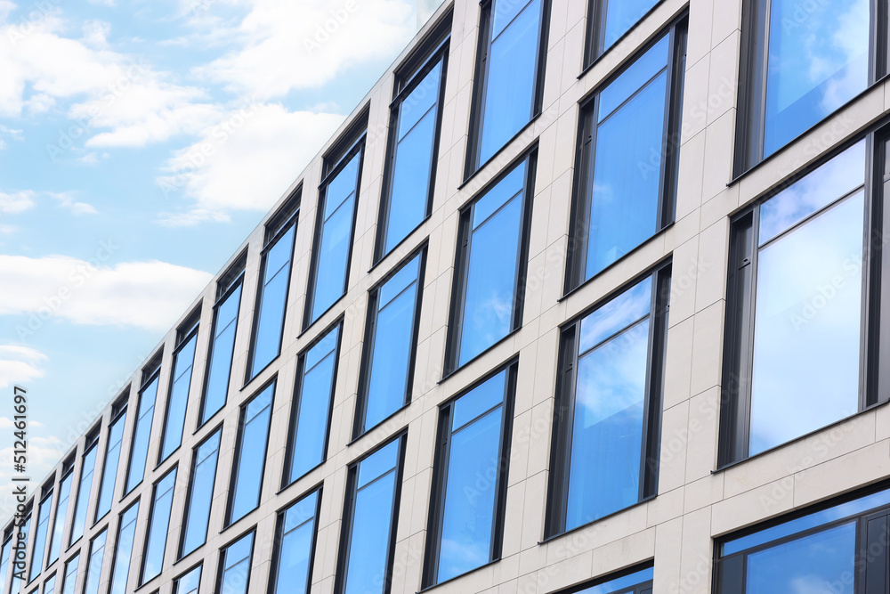 Obraz premium Modern building against blue sky, low angle view