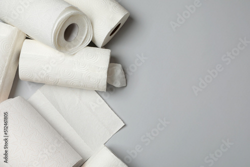 Many rolls of paper towels on grey background, flat lay. Space for text