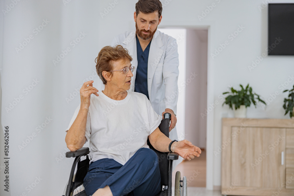 Professional doctor brought the patient in wheelchair to hospital ward in clinic. High quality photo Professional doctor brought the patient in wheelchair to hospital ward in clinic. High quality photo