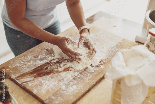 Kneading pizza dough by hand on the kitchen board is the key to the quality of homemade pizza