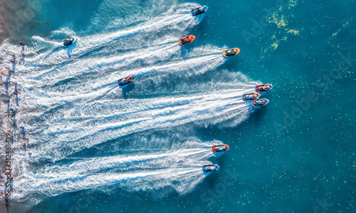 Aquabike championship on Jarun lake, Zagreb Croatia. Aerial view of the speed watercrafts in clear blue water at sunset in summer. Top view from drone of fast motorboats. Race. Water scooter