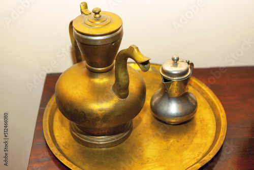 Ancient vessel for boiling water . Golden teapot