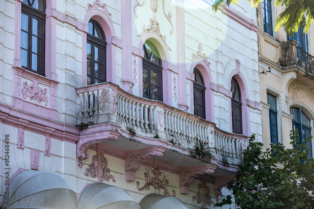 An old architectural building with a stone balcony. The facade of the ...