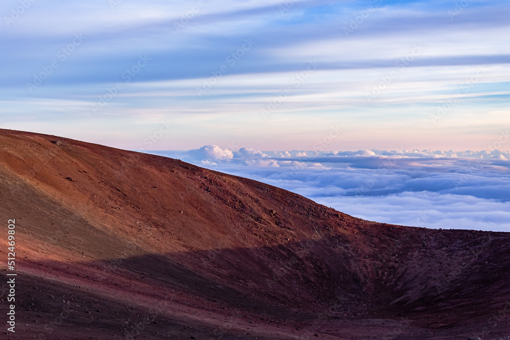 Beautiful layers of colors, muntain range, clouds, and the sun in Mauna Kea, Hawaii