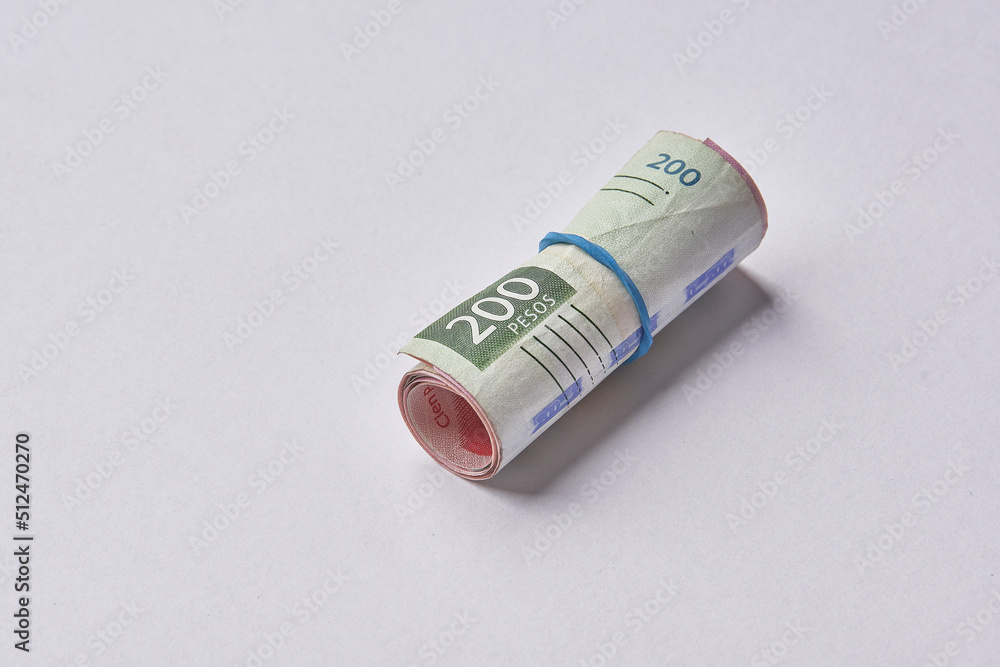 Mexican money, Mexican pesos bills and coins on white background Mexican money, Mexican pesos bills and coins on white background