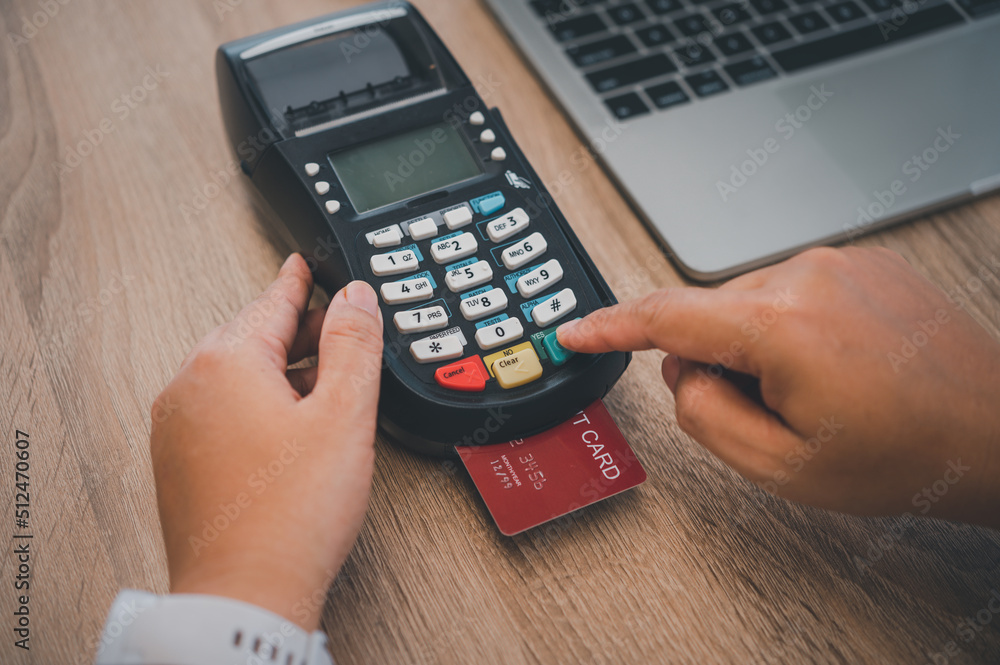 Paying by credit card , buying and selling products using a credit card swipe machine. Paying by credit card , buying and selling products using a credit card swipe machine.
