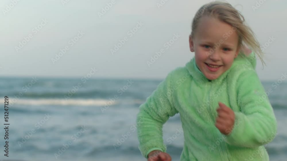 Happy kid running against ocean background Happy kid running against ocean background