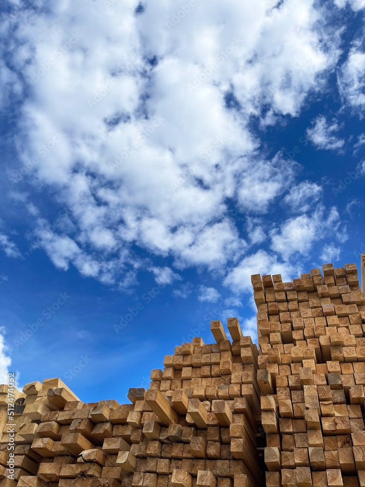 Wooden boards, lumber, industrial wood, timber. Pine wood timber stack of natural rough wooden boards on building site. Industrial timber building materials Wooden boards, lumber, industrial wood, timber. Pine wood timber stack of natural rough wooden boards on building site. Industrial timber building materials
